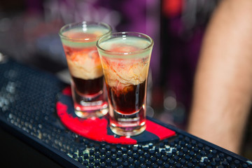 Alcohol cocktail on the bar. Bartender prepares an alcoholic cocktail