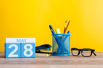 May 28th. Day 28 of month, calendar on business office table, workplace at yellow background. Spring time