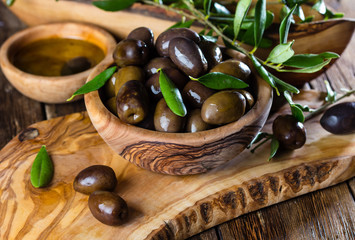 Olives and olive oil in olive wooden bowls - Powered by Adobe