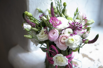 the Spring bouquet of pink Ranunculus, lisianthus and Veronica for a special wedding ceremony