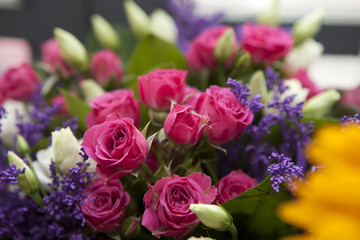 Spring bouquet of red rose, lisianthus and lilac a for a special wedding ceremony