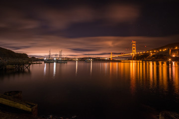 Fototapeta na wymiar Sailboats Sway in evening sky of a San Francisco Harbor