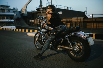 Fototapeta na wymiar Cute young brunette woman and motorcycle 