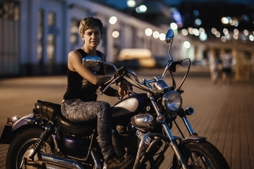 Fototapeta na wymiar Cute young brunette woman and motorcycle 