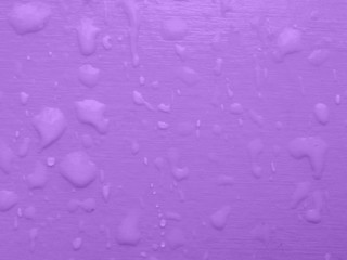 Rain drops on a delicate purple background, texture