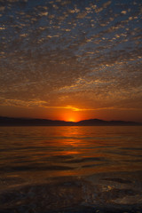 dazzling display of clouds at sunrise over the ocean