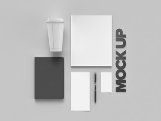 Stylish office workplace in monochrome on a gray background with sign design, mock up. Presentation. Frame. Blank notebook and phone. Flat lay.