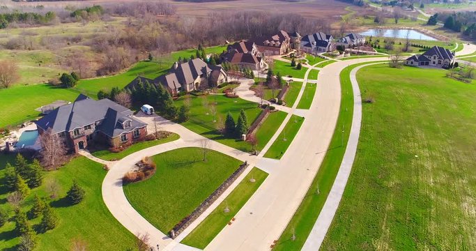 Stunning mansion homes line hillside, breathtaking aerial view of upper class neighborhood.