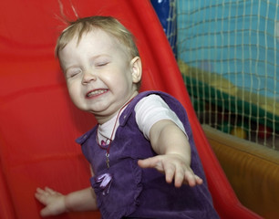 Fototapeta na wymiar A child riding a roller coaster
