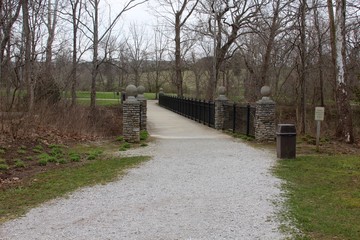 The walkway bridge in the park on a overcast day.