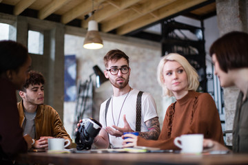 Group of young entrepreneurs in a meeting with VR headset