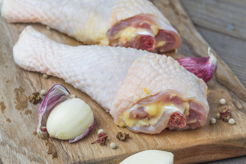 Raw chicken legs on cutting board