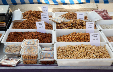 Many bags of various types of nuts for sale at Sunday market in Spain, Mercadillo de Campo de Guardamar