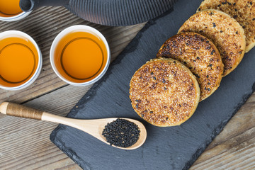 The teapot and tea on the wooden table, delicious snacks