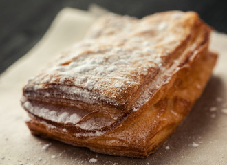 Puff pastry pie on a paper macro shot