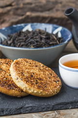 The teapot and tea on the wooden table, delicious snacks
