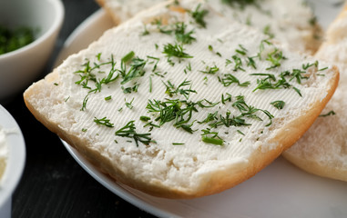 White bread with cream cheese and fresh green dill, closeup