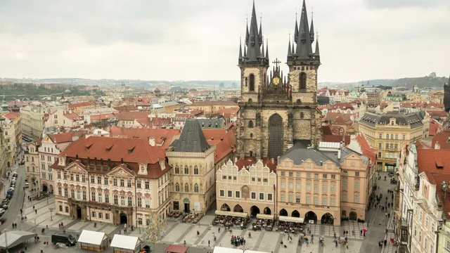 Old Town Hall with its huge towers, historic multistoreyed  buildings, covered with red tile, impressive view,  rushing back and forth tourists, in the daytime in spring, taken  as a timelapse shot