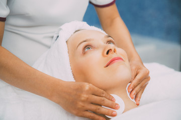 Fototapeta na wymiar Young Caucasian Woman Getting Facial Treatment