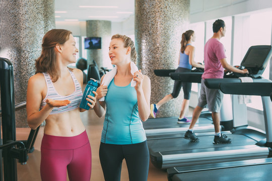 Two Young Women Talking after Training in Gym