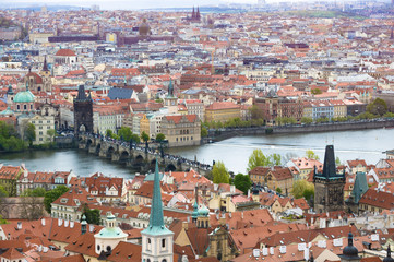 Fototapeta na wymiar Panorama of Prague with Red Roofs from Above Summer Day at Dusk, View from the height, The Charles Bridge Czech Republic