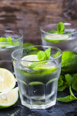 Mojito cocktail in a bur on a rustic table, selective focus