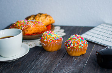 Delicious homemade muffins with yogurt, on a wooden background with space for text.