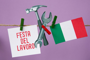 1 May Workers Day or Labour day  text in italian. italy flag, Hammer and wrench - grunge abstract image 