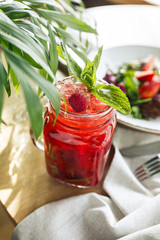 Refreshing red cocktail with strawberries