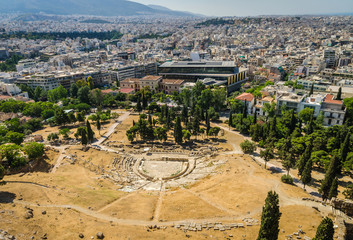 Ancient theater of Dionysus ruins and Athens panorama.