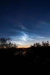 Noctilucent clouds at night sky