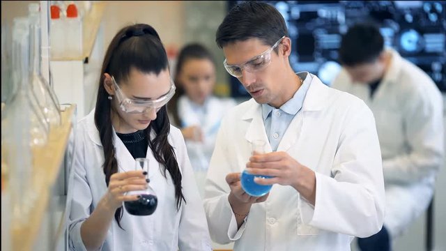 Group of laboratory scientists discussing their research at the lab