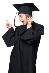 Emotional portrait of a graduate little happy girl student in a black graduation gown with hat, isolated on white background. Lucky cheerful schoolgirl celebrating triumph.