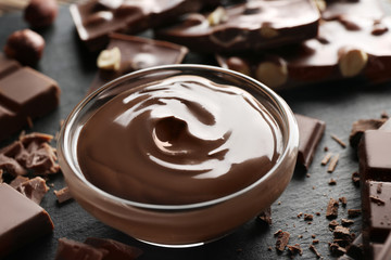 Bowl with melted chocolate and chopped bars, closeup