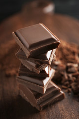 Stack of chocolate pieces on table, closeup