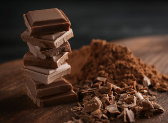 Stack of chocolate pieces on table, closeup