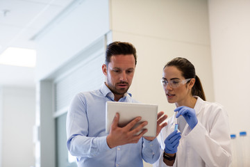 Female scientist discussing results of experiment with male colleague