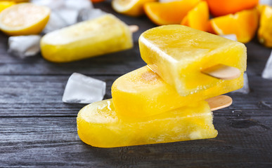 Delicious citrus ice-cream on dark wooden background