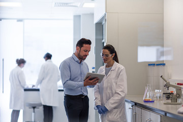 Female scientist discussing data with pharmaceutical sales rep