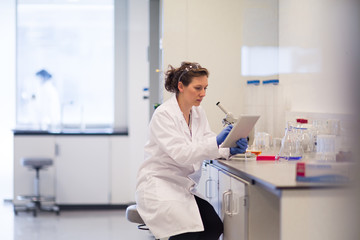 Female scientist using digital tablet