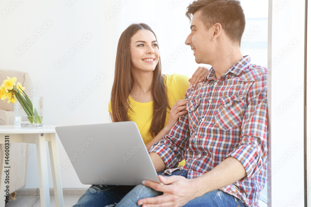 Canvas Prints Happy young couple with laptop at home