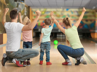 Family having fun at bowling club