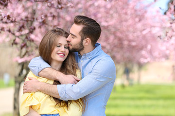 Fototapeta premium Young lovely couple walking in spring park