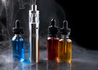 Electronic cigarette and vape liquids within vapor on black background