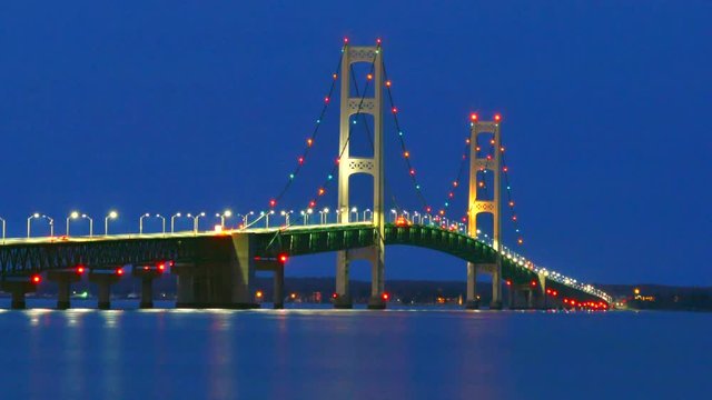 The lights of scenic, Majestic Mackinac Bridge sparkle in deep blue predawn twilight, Upper Peninsula of Michigan.
