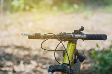 Riding a mountain bike on nature background, close up bicycle detail with bokeh background