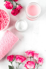 Fototapeta na wymiar Nail care spa set with rose cream, towel white background top view