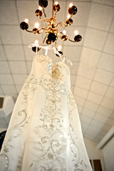 Wedding Dress Hanging from Chandelier