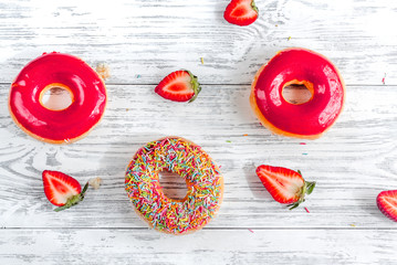 lunch with donuts and strawberry on wooden table background top view