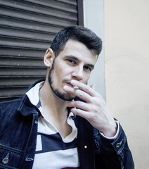 middle age man smoking cigarette on bacyjard, stylish tough guy, lifestyle people concept 